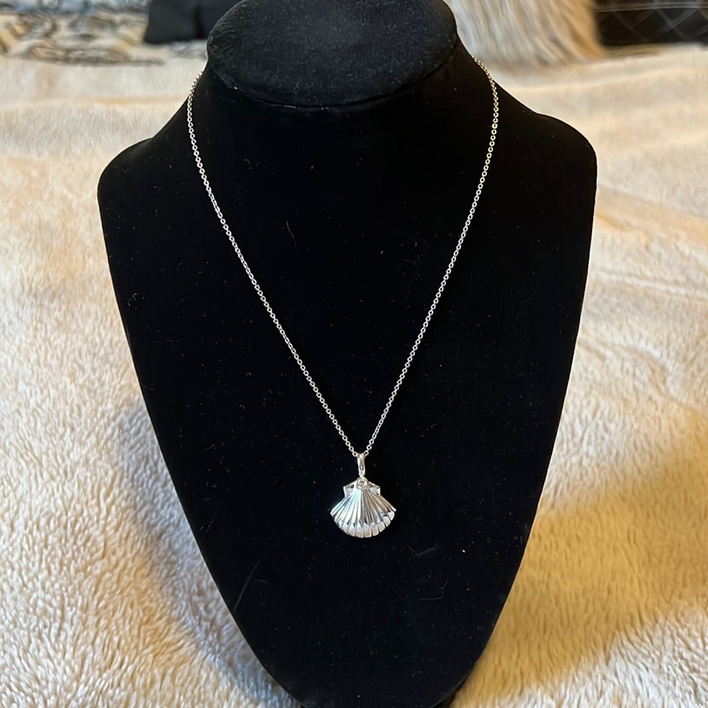 Silver plated seashell charm necklace with cubic zirconia gem on shell